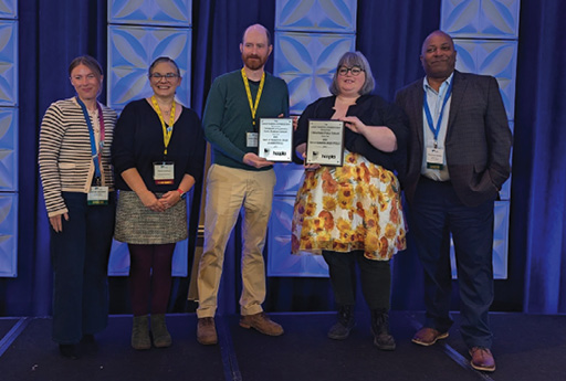 Library Marketing Conference Group board president Maria Atilano (second from left) poses with both Best of Marketing Award winners, who are flanked by staffers from award sponsor hoopla Digital.